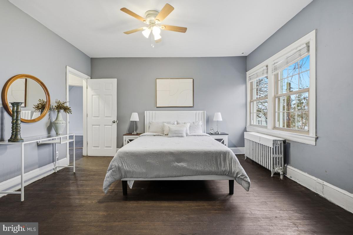 6712 6th Street Northwest Washington, DC 20012 - Photo 23 of 41 a spacious bedroom with a bed and a chandelier