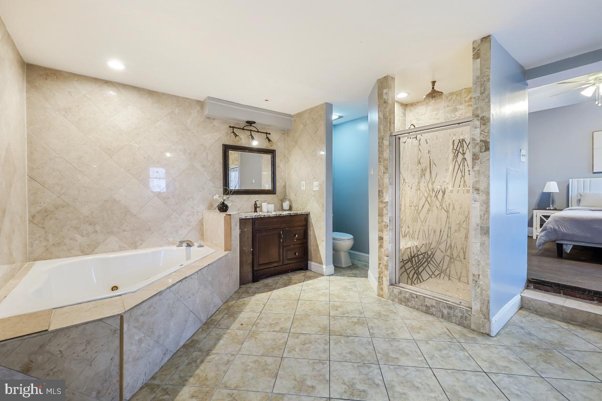 6712 6th Street Northwest Washington, DC 20012 - Photo 24 of 41 a bathroom with a tub a mirror and a shower