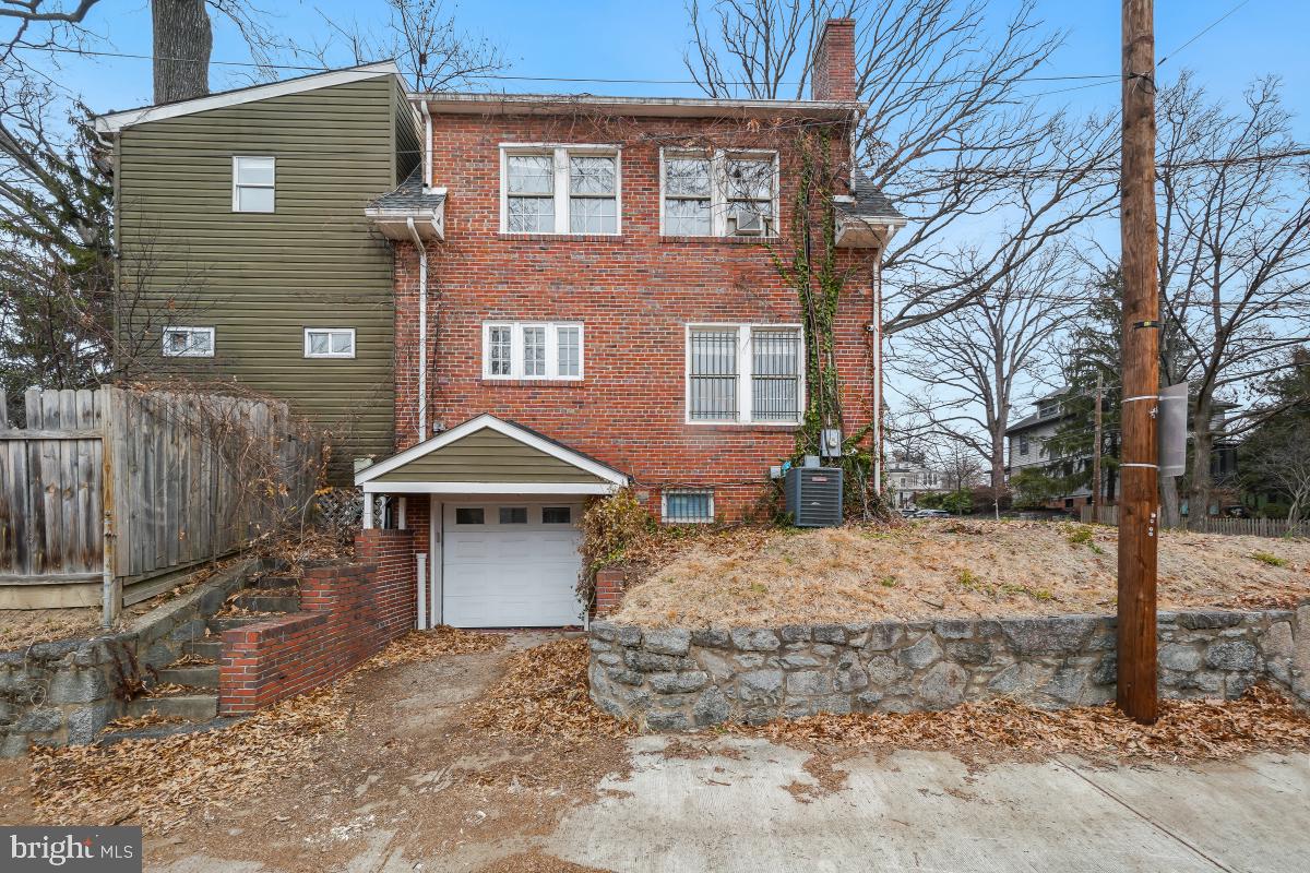 6712 6th Street Northwest Washington, DC 20012 - Photo 37 of 41 a front view of a house with a yard and garage