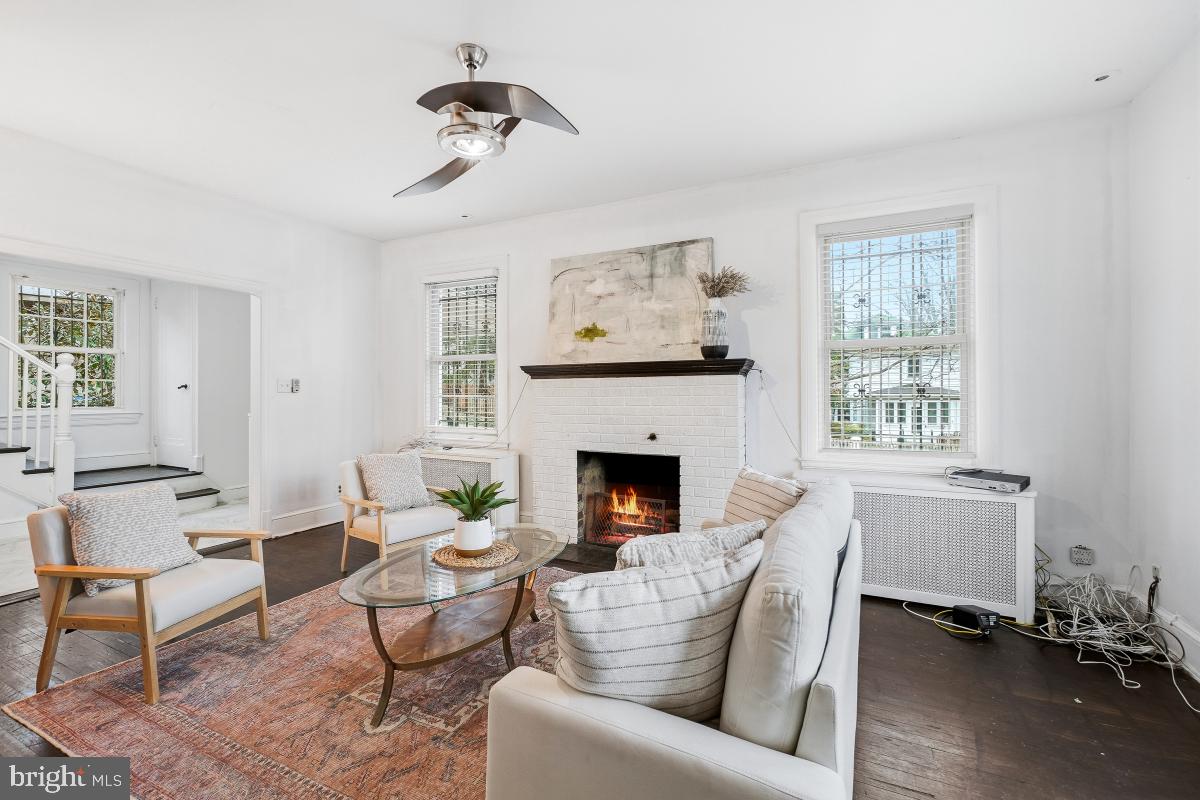 6712 6th Street Northwest Washington, DC 20012 - Photo 10 of 41 a living room with furniture two windows and a fireplace