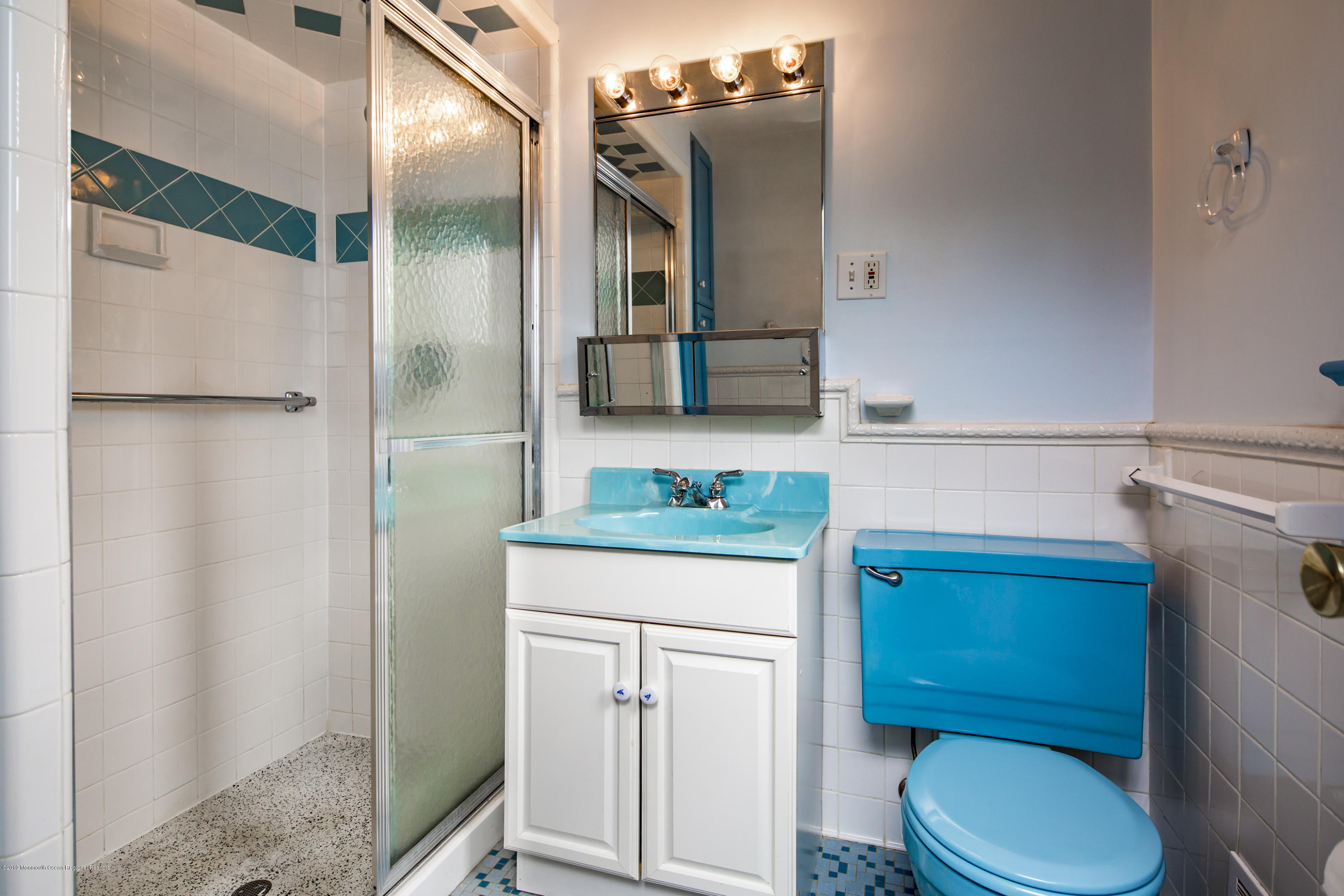 503 Wildwood Road West Allenhurst, NJ 07711 - Photo 22 of 26 a bathroom with a toilet a sink and a mirror