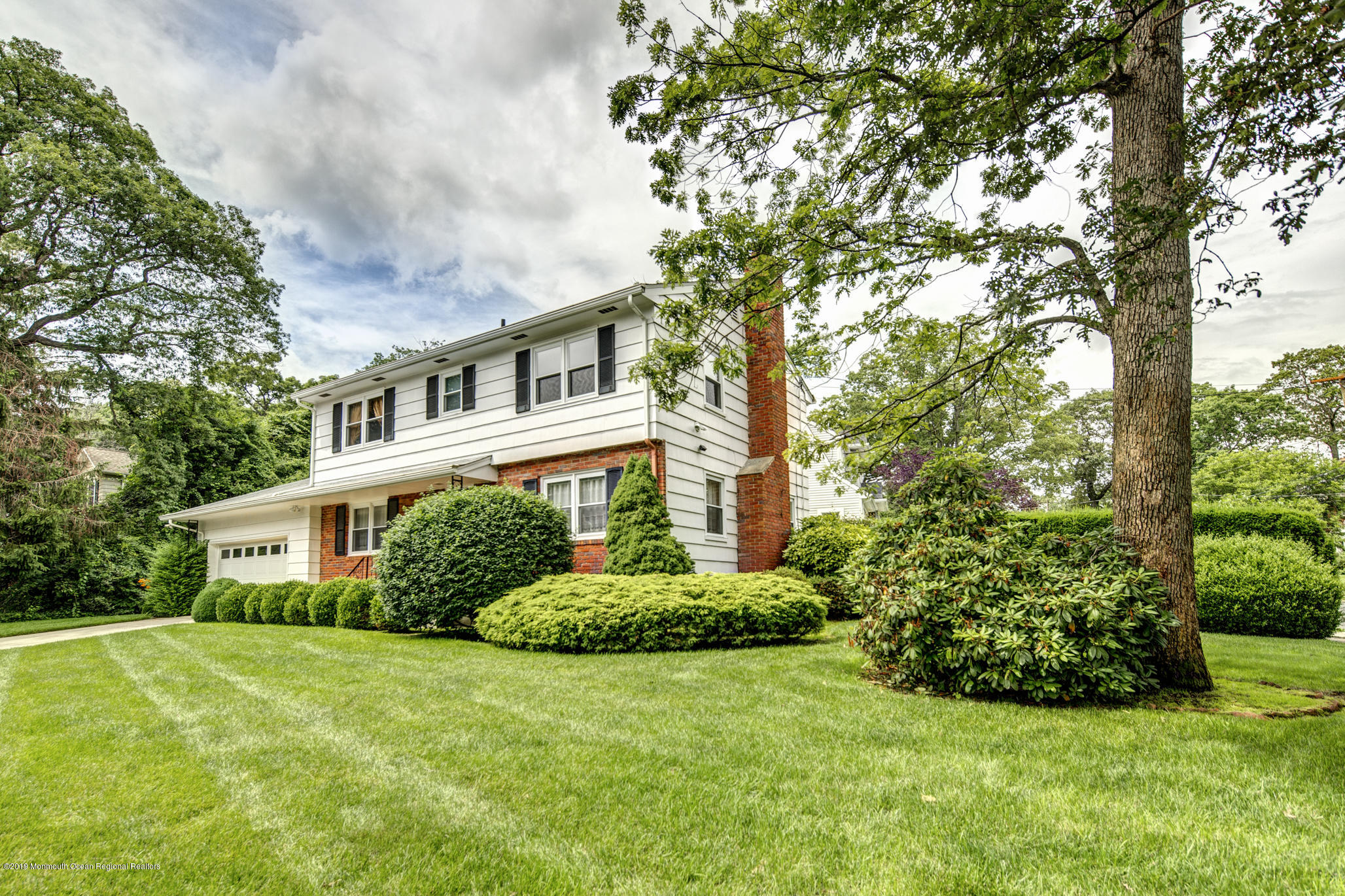 503 Wildwood Road West Allenhurst, NJ 07711 - Photo 3 of 26 a front view of a house with a yard