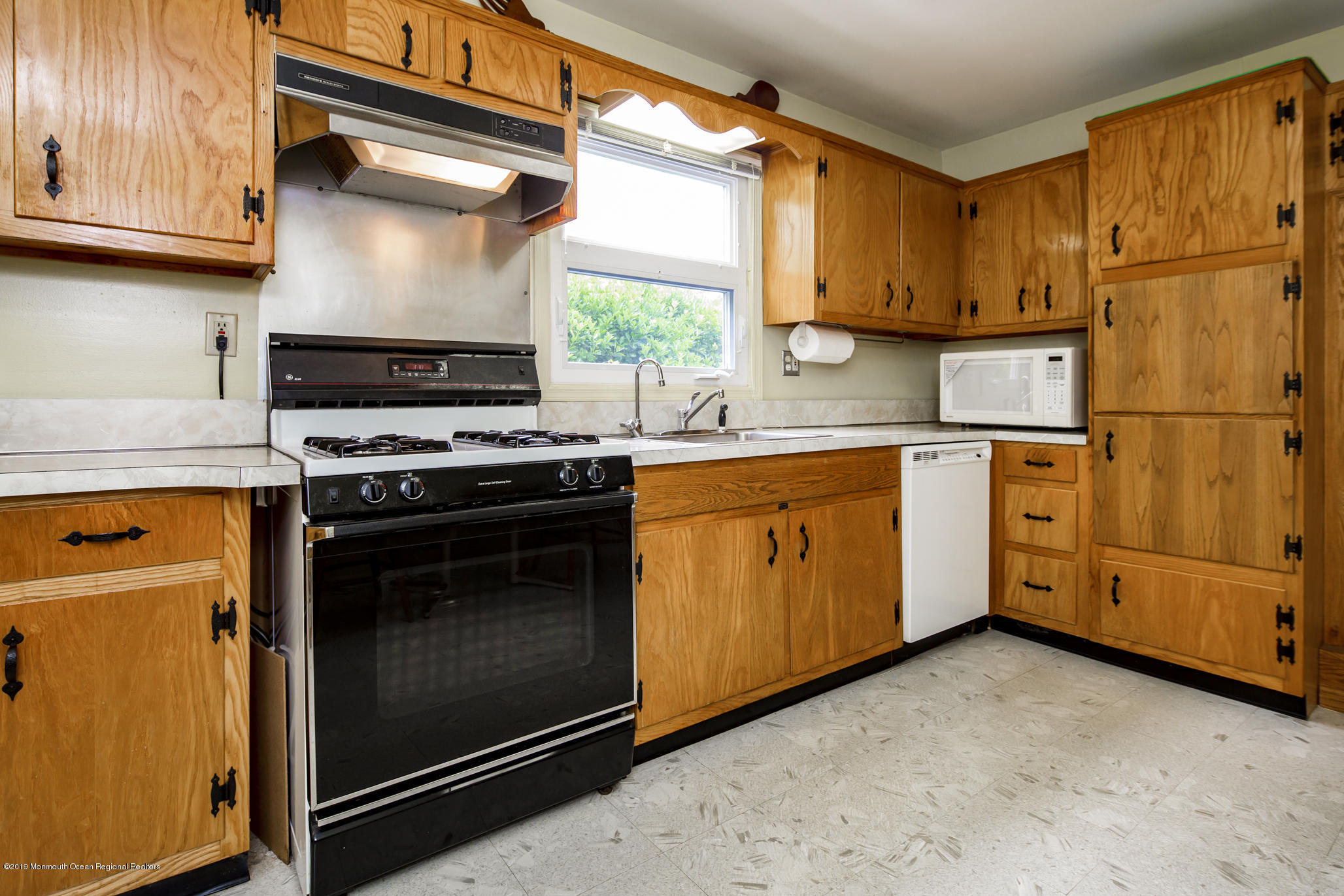 503 Wildwood Road West Allenhurst, NJ 07711 - Photo 9 of 26 a kitchen with stainless steel appliances granite countertop a stove a sink and a microwave