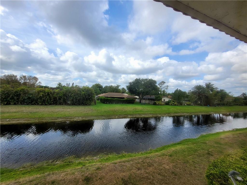 11096 Royal Palm Boulevard, Unit 11096 Coral Springs, FL 33065 - Photo 12 of 20 a view of a lake with outdoor space