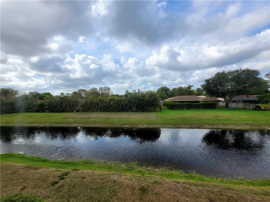 11096 Royal Palm Boulevard, Unit 11096 Coral Springs, FL 33065 - Photo 13 of 20 a view of a lake with a yard