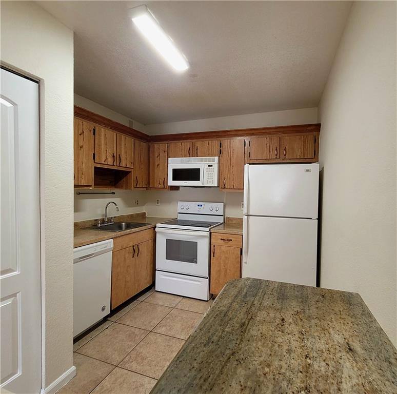 11096 Royal Palm Boulevard, Unit 11096 Coral Springs, FL 33065 - Photo 3 of 20 a kitchen with a refrigerator stove and microwave