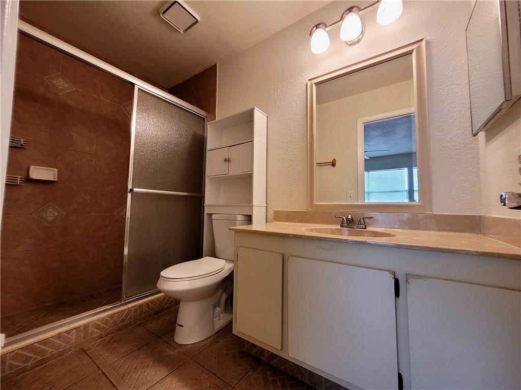 11096 Royal Palm Boulevard, Unit 11096 Coral Springs, FL 33065 - Photo 8 of 20 a bathroom with a granite countertop toilet sink and mirror
