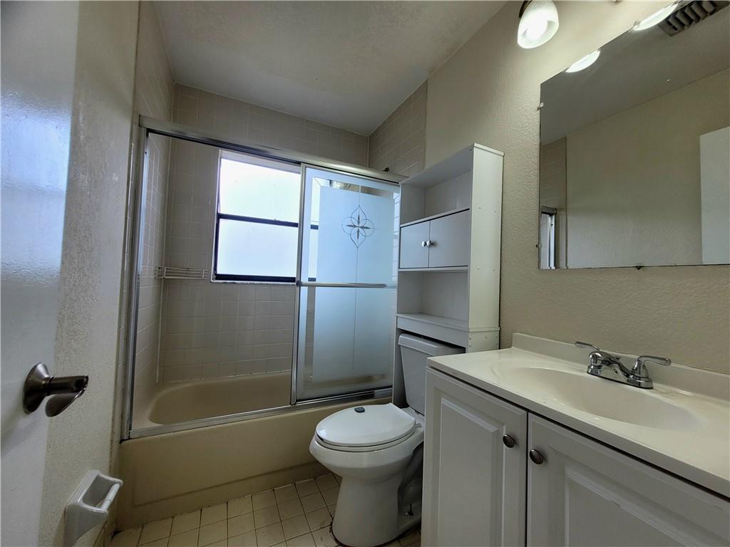 11096 Royal Palm Boulevard, Unit 11096 Coral Springs, FL 33065 - Photo 10 of 20 a bathroom with a sink toilet and shower