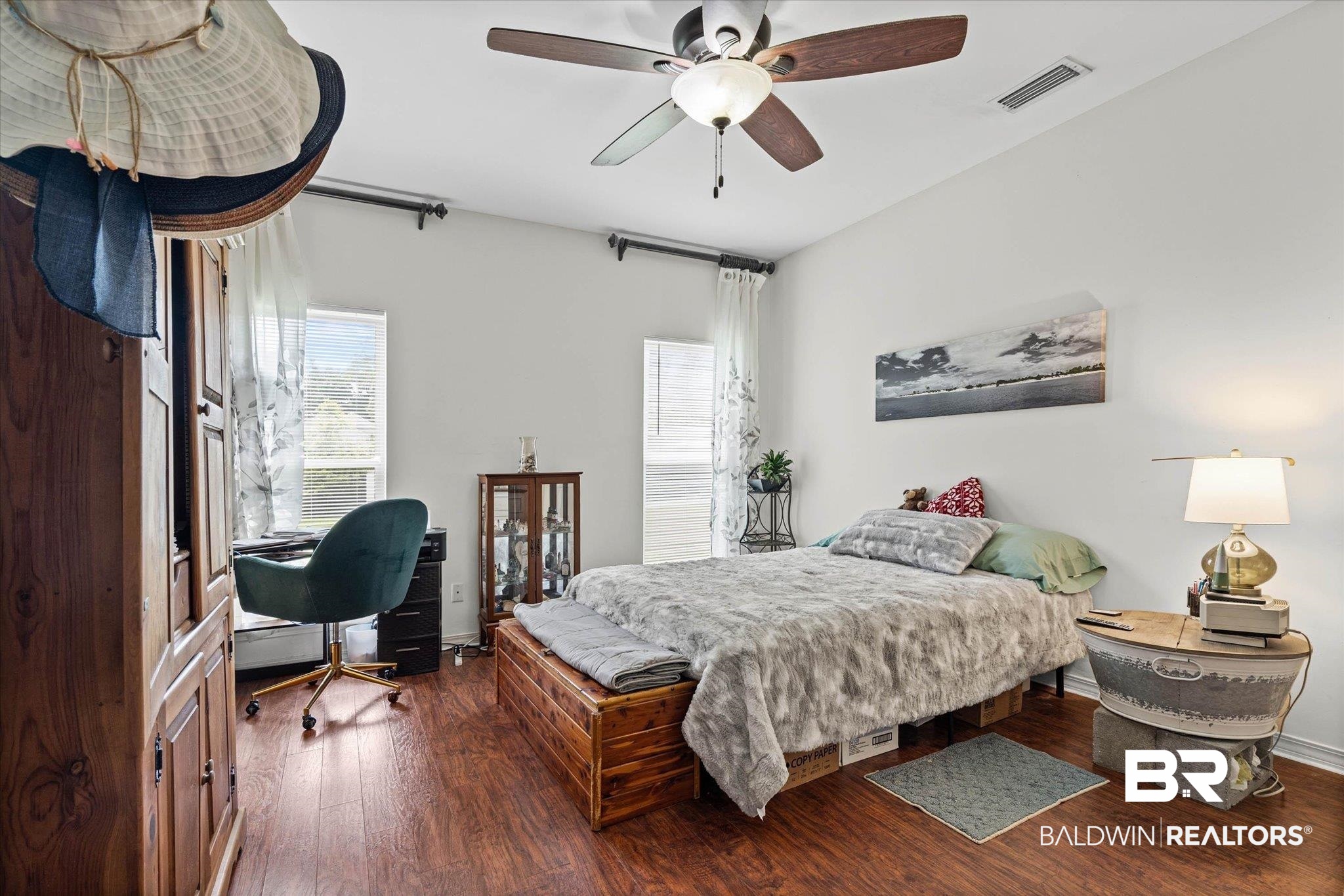 800 Galoway Avenue Mobile, AL 36609 - Photo 11 of 22 Spacious room featuring wood-finish flooring, a ceiling fan with light fixture, and multiple windows providing natural light