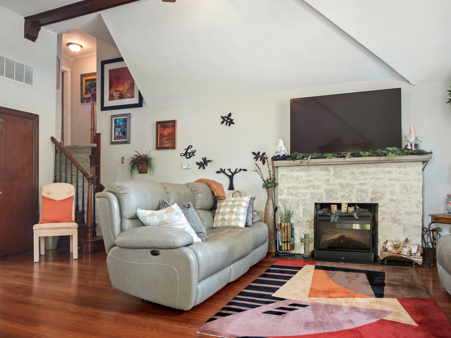72 Radnor Lane Crete, IL 60417 - Photo 5 of 25 a living room with furniture a flat screen tv and a fireplace