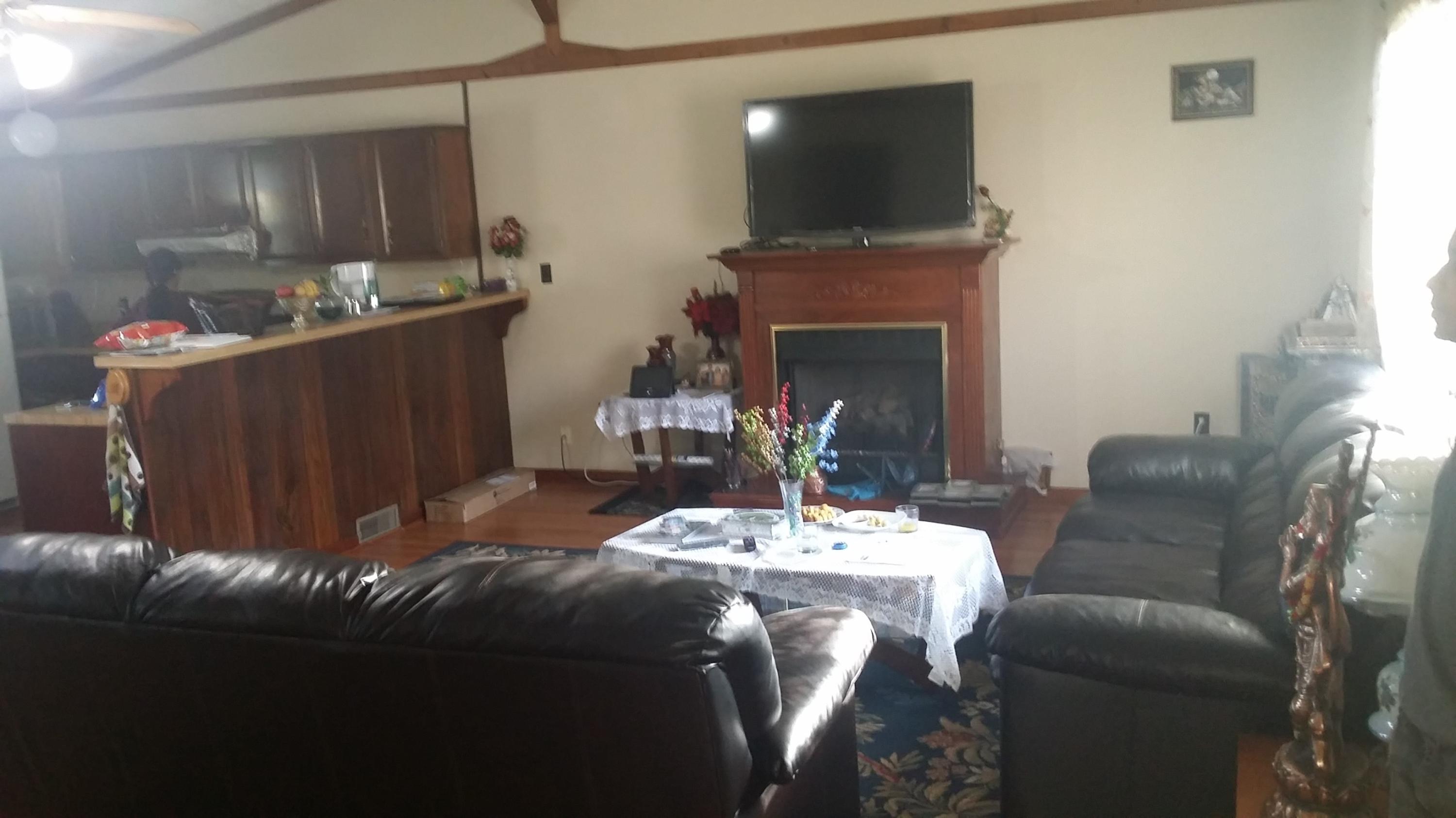 719 Olney Road Vinton, VA 24179 - Photo 2 of 15 a living room with furniture a flat screen tv and a fireplace
