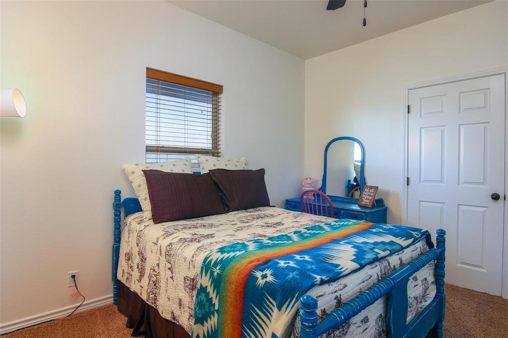 7158 Luella Road Sherman, TX 75090 - Photo 15 of 40 a bedroom with a bed and a dresser