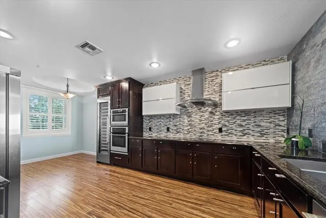 a view of kitchen with sink and refrigerator