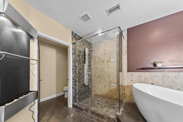 a bathroom with a shower and mirror