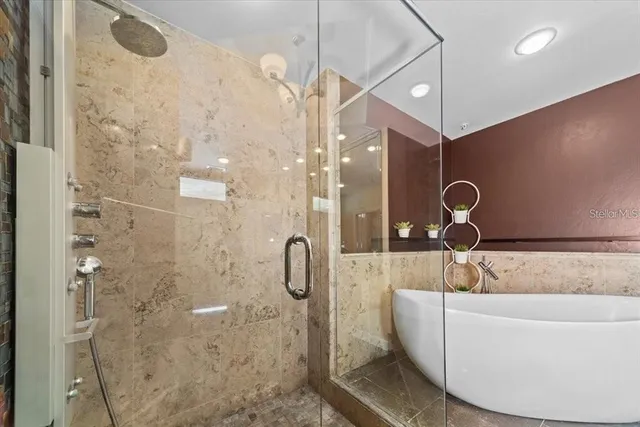 a bathroom with a tub sink and mirror