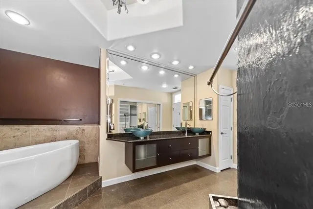 a bathroom with a granite countertop shower and a toilet