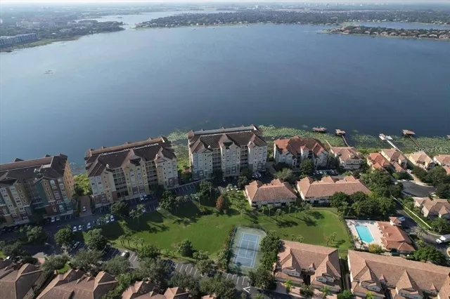 an aerial view of a house with outdoor space and lake view