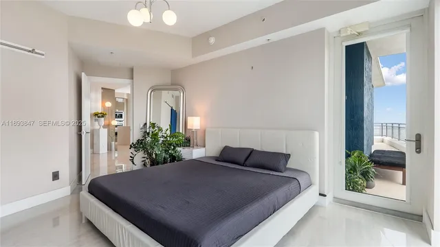 a bedroom with a bed and a potted plant