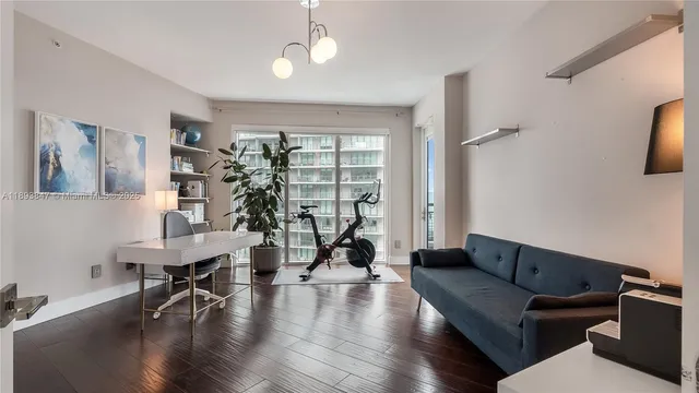 a living room with furniture and a chandelier