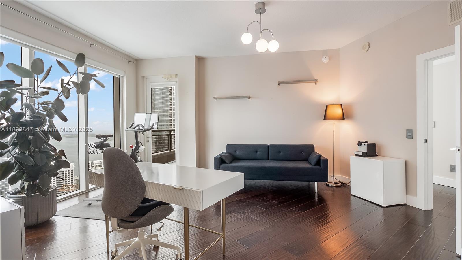 60 Southwest 13th Street, Unit 4200 Miami, FL 33130 - Photo 23 of 52 a living room with furniture and a chandelier