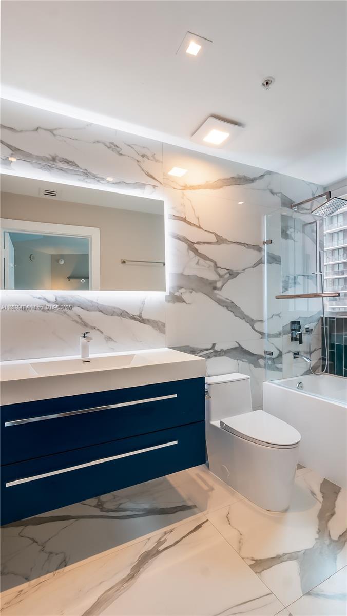 60 Southwest 13th Street, Unit 4200 Miami, FL 33130 - Photo 28 of 52 a bathroom with a sink and a mirror