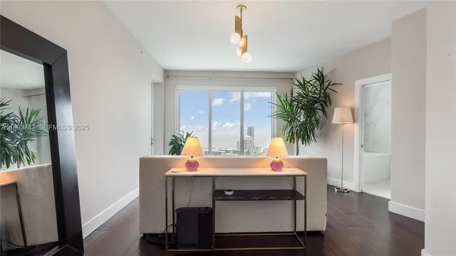 a spacious bedroom with a balcony a bed and a potted plant