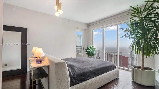 a bedroom with a bed and a potted plant