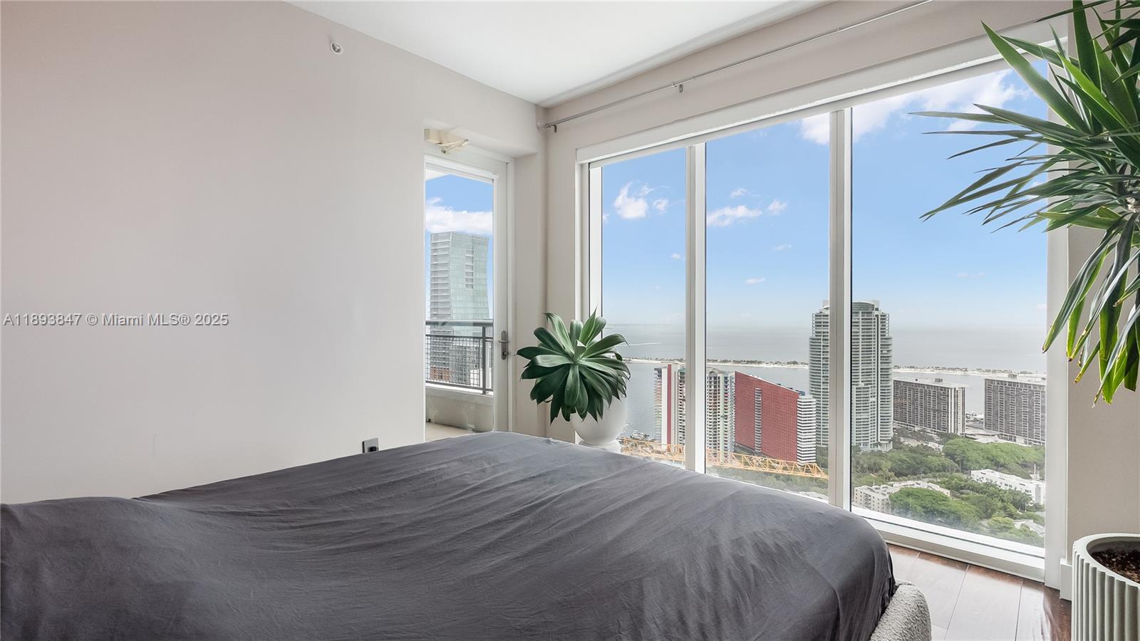 60 Southwest 13th Street, Unit 4200 Miami, FL 33130 - Photo 33 of 52 a bedroom with a bed and a potted plant