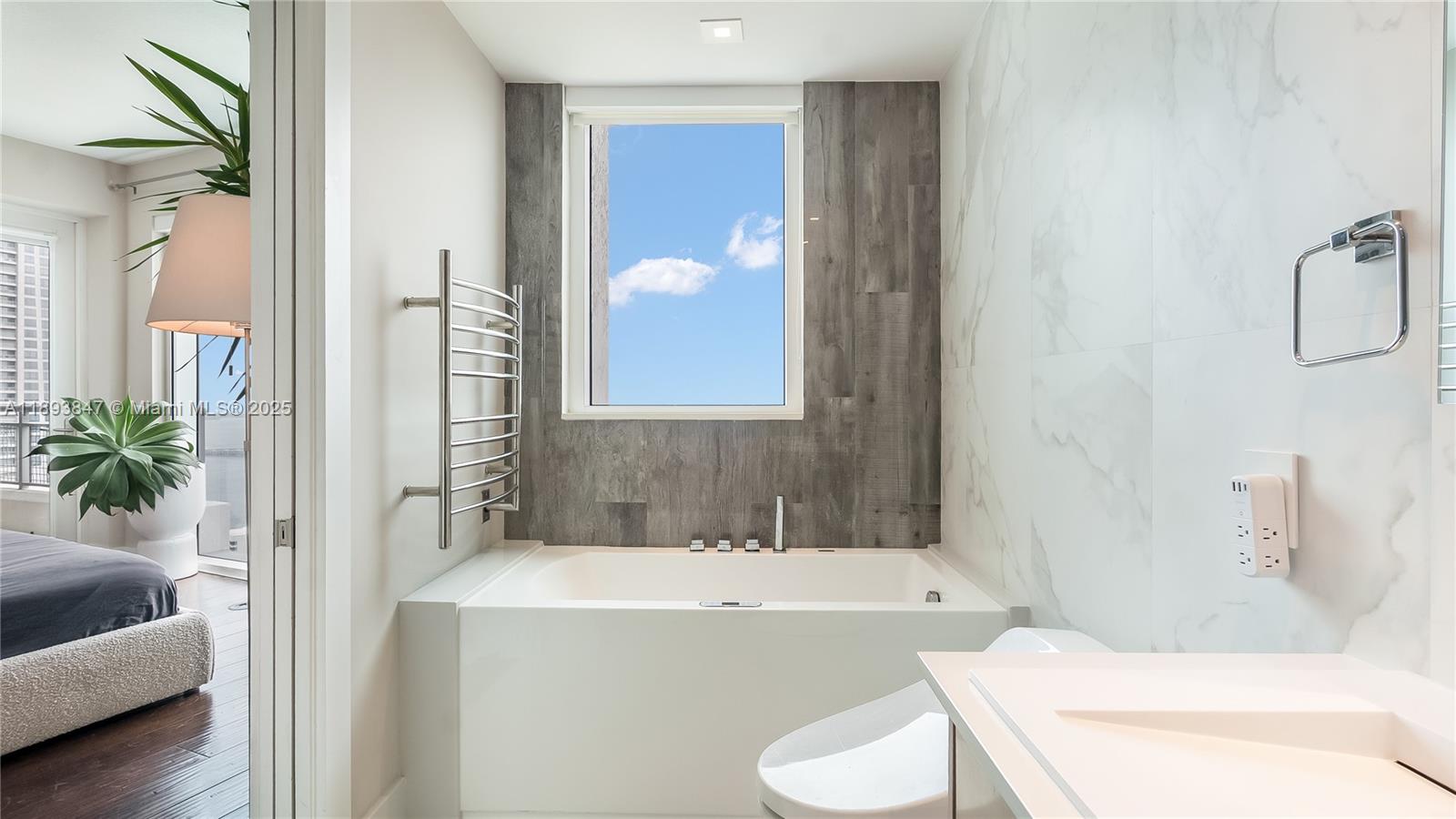 60 Southwest 13th Street, Unit 4200 Miami, FL 33130 - Photo 35 of 52 a bathroom with a sink a toilet and a bathtub