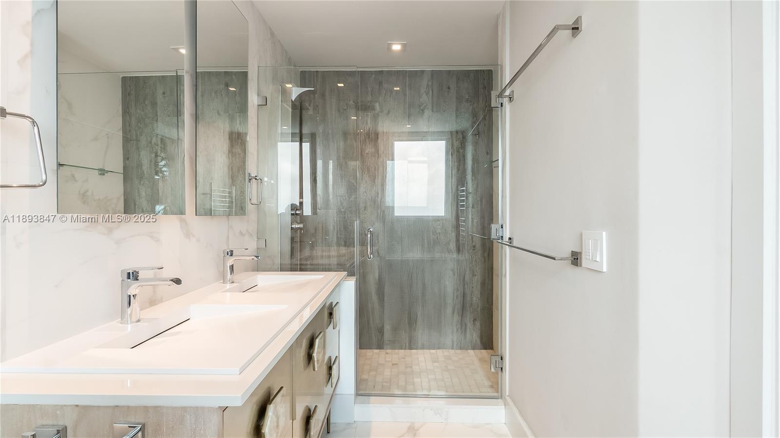 60 Southwest 13th Street, Unit 4200 Miami, FL 33130 - Photo 36 of 52 a bathroom with a sink and a mirror