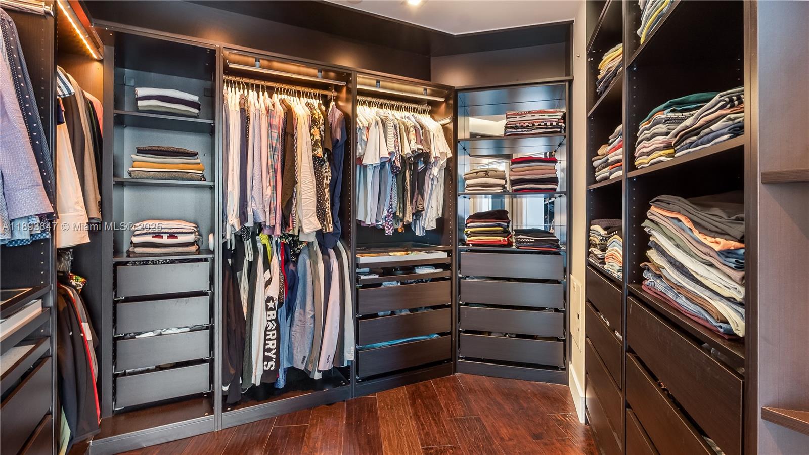 60 Southwest 13th Street, Unit 4200 Miami, FL 33130 - Photo 37 of 52 a view of walk in closet with clothes and shoes