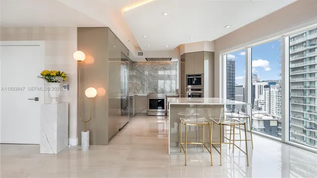 a view of a hallway with dining area and chandelier