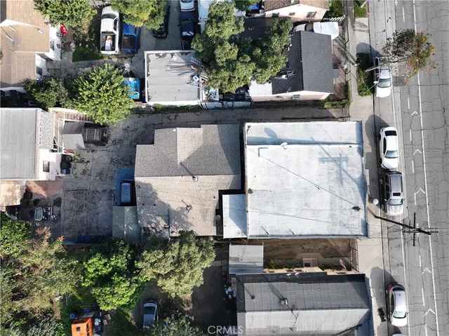 a aerial view of a house with car parked