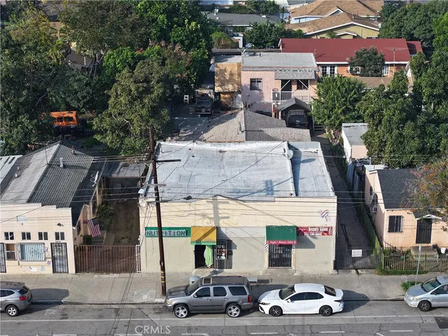 an aerial view of a houses with street