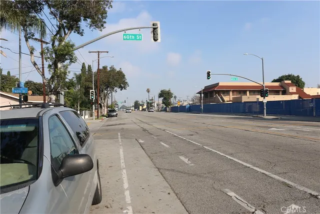 a view of a patio with a table and chairs under an umbrella