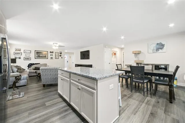 a open kitchen with white cabinets and stainless steel appliances