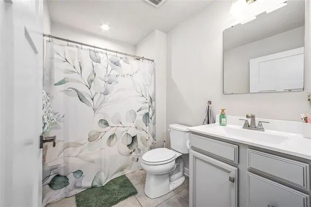 a bathroom with a toilet sink and shower