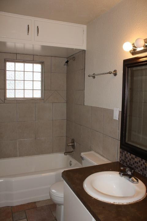 3111 30th Street Lubbock, TX 79410 - Photo 13 of 22 a bathroom with a sink a toilet and bathtub