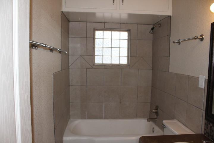 3111 30th Street Lubbock, TX 79410 - Photo 14 of 22 a bathroom with a bathtub