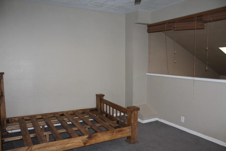 3111 30th Street Lubbock, TX 79410 - Photo 19 of 22 a bedroom with a bed and cabinets