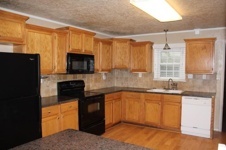 3111 30th Street Lubbock, TX 79410 - Photo 4 of 22 a kitchen with a sink stove and refrigerator