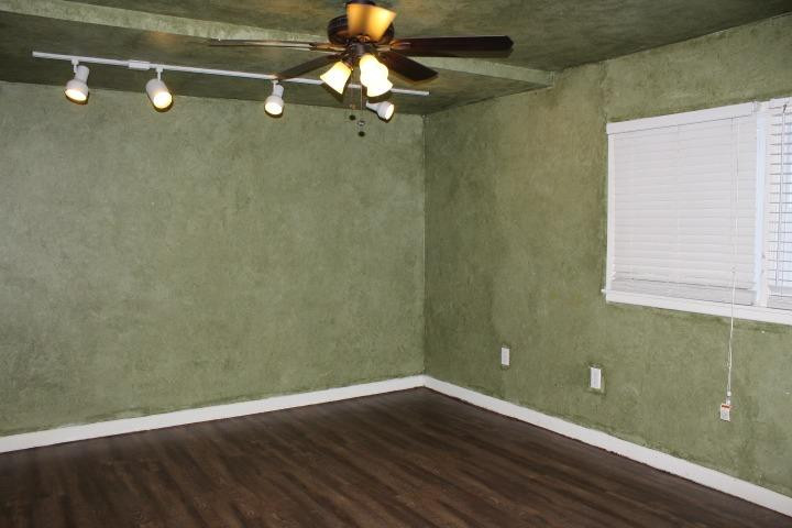 3111 30th Street Lubbock, TX 79410 - Photo 6 of 22 a view of a room with wooden floor and fan