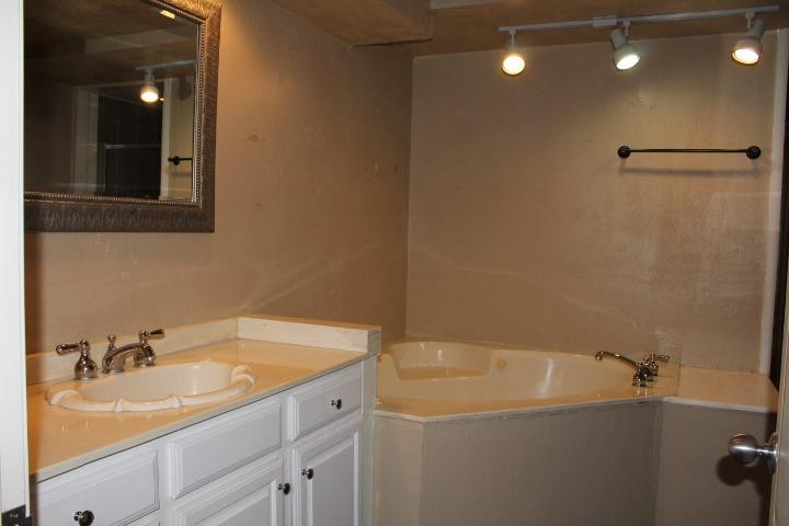 3111 30th Street Lubbock, TX 79410 - Photo 8 of 22 a bathroom with a sink and a tub