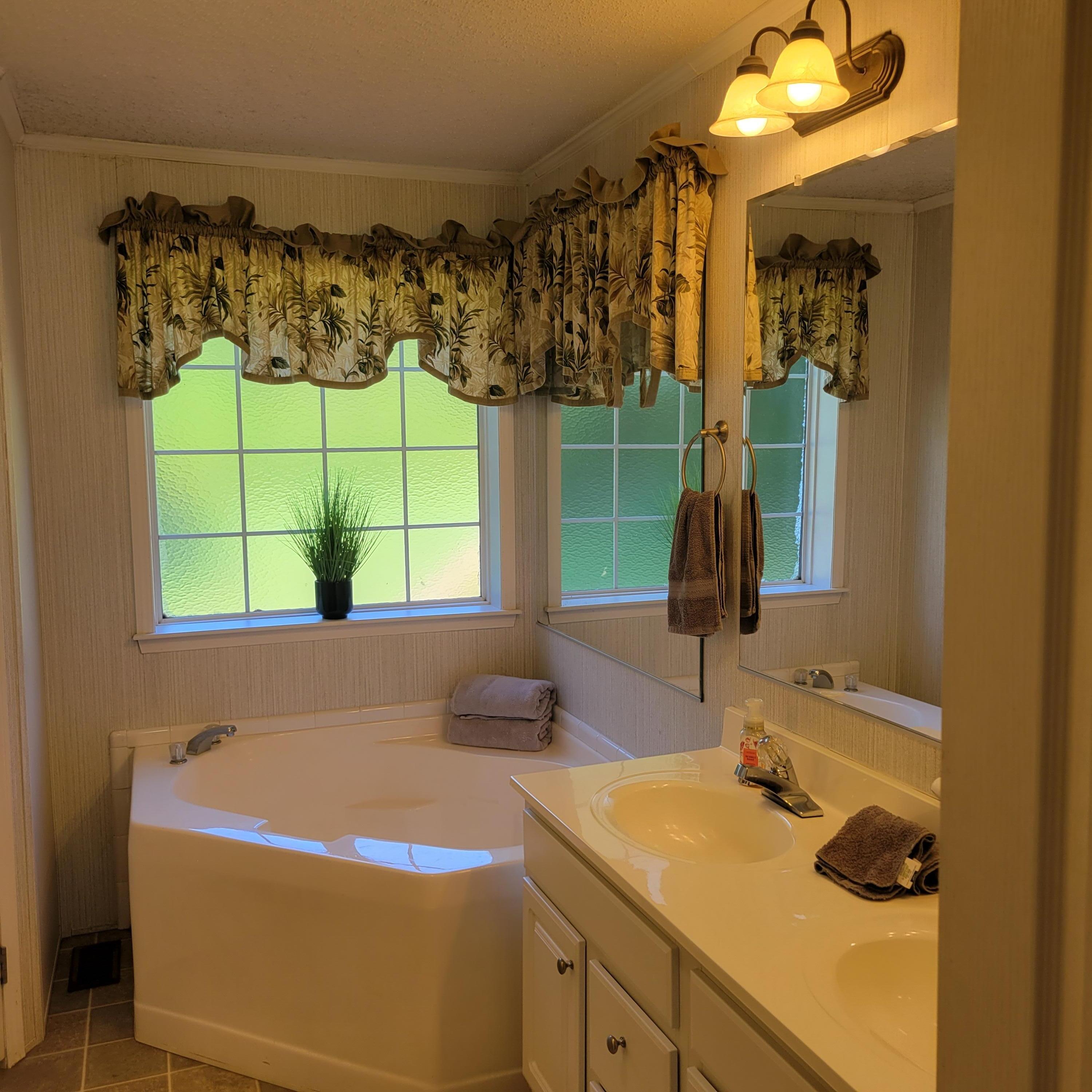 1698 Oakwood Road Thomson, GA 30824 - Photo 27 of 49 2 person tub with a seat and grab handle for easy access in and out.