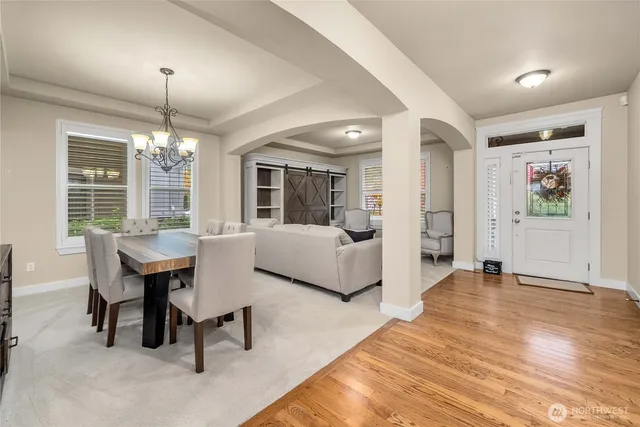 a living room with furniture and a chandelier