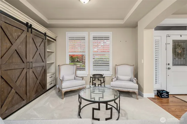 a living room with furniture a rug and a window