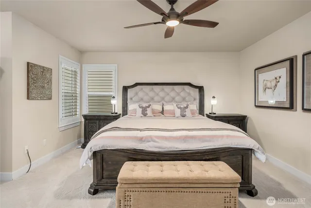 a bed sitting in a bedroom next to a window