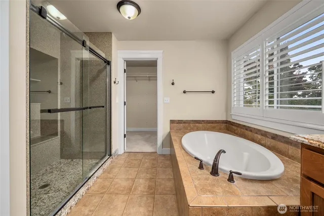 a bathroom with a tub and a shower