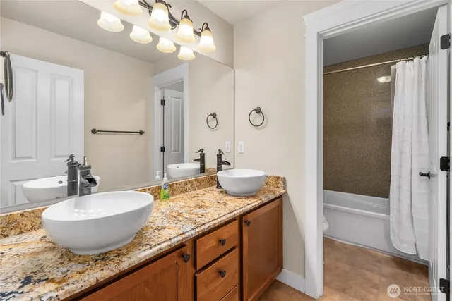 a view of a granite countertop sink and a mirror