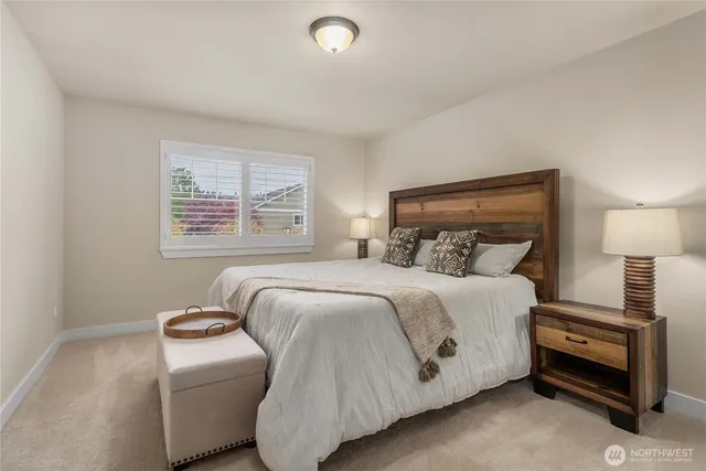 a bedroom with a bed and a lamp